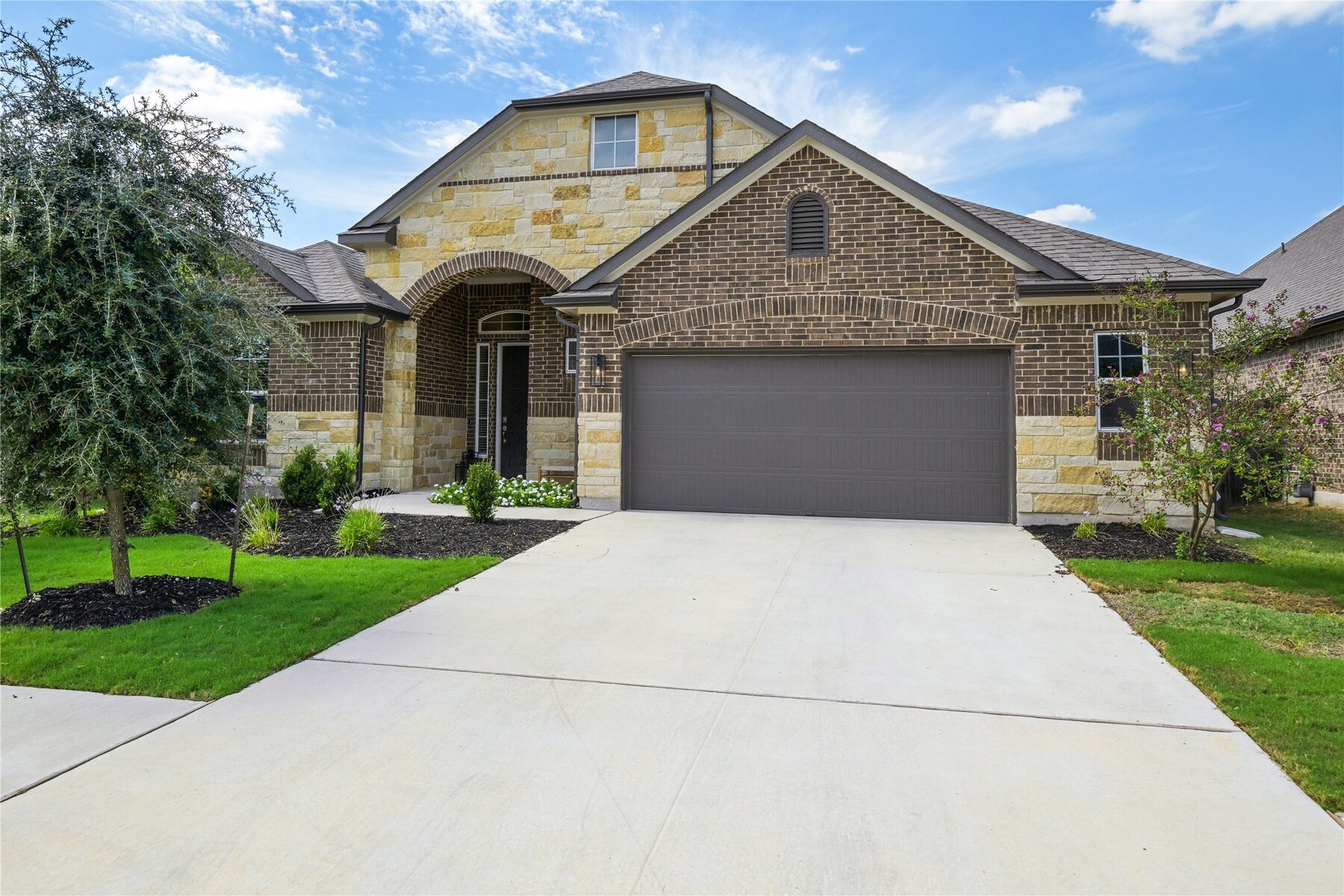 Stone and brick exterior of 238 Wild Pecan Loop in Buda